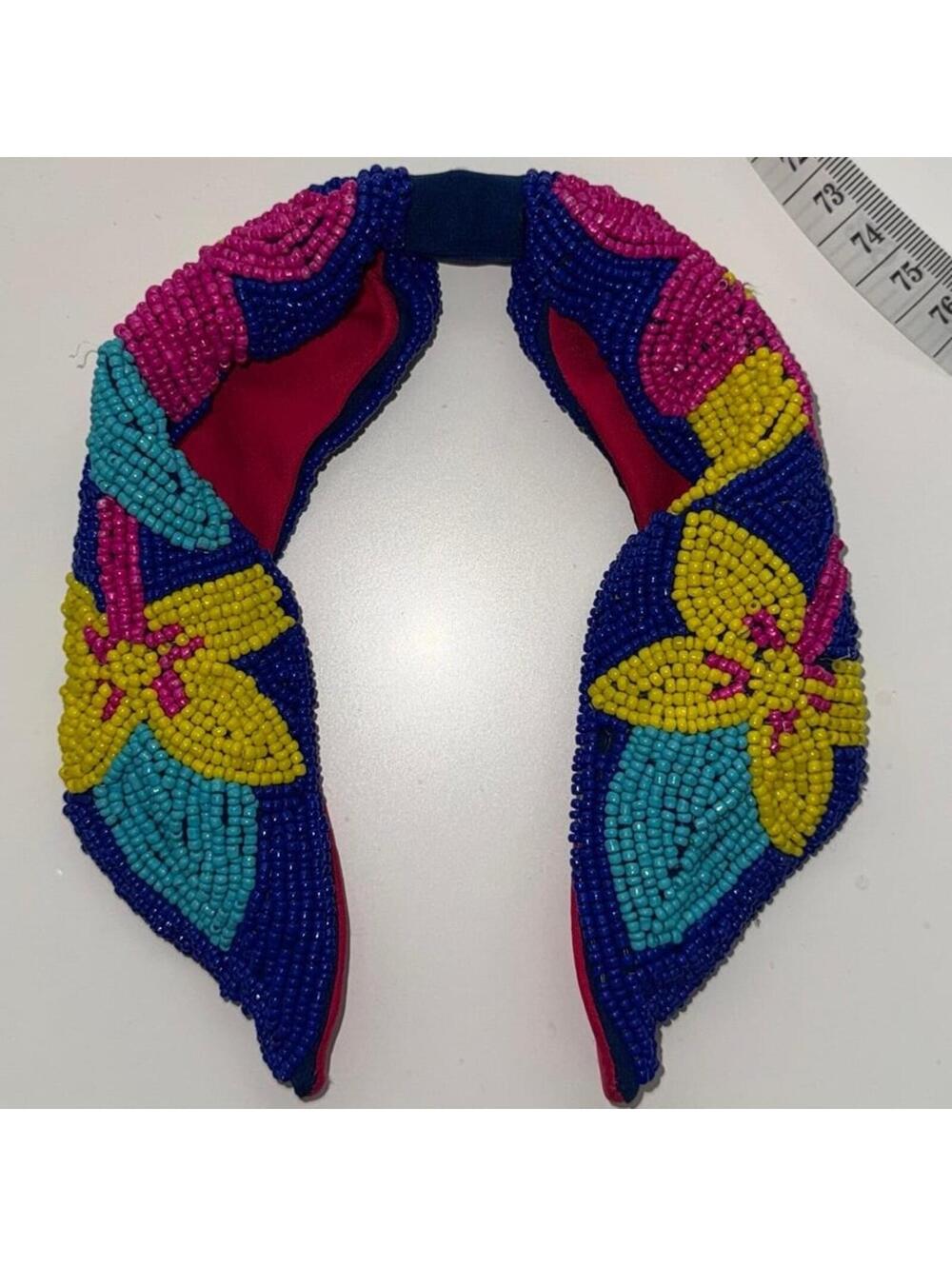 beaded fabric knotted headband featuring a floral design in blue, pink, & yellow